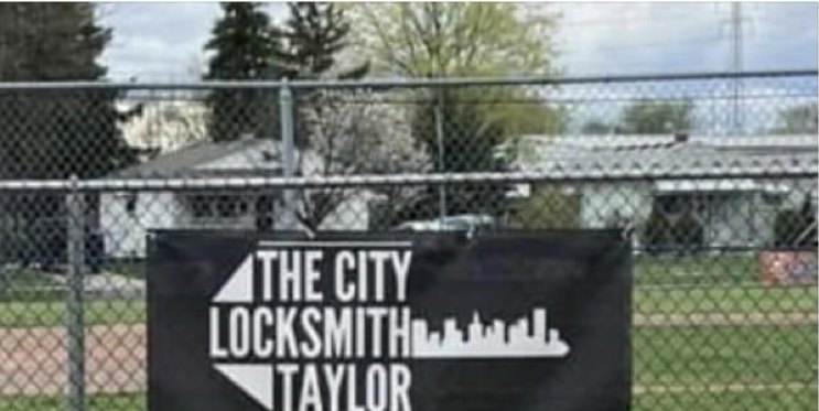City Locksmith Taylor banner on a local baseball field fence