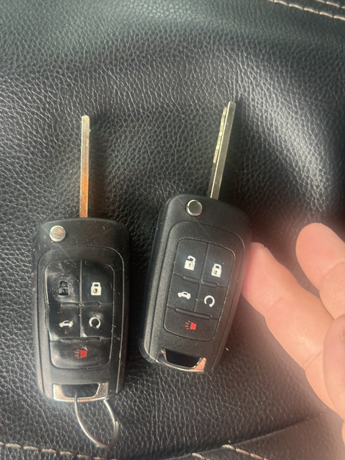 Worn Chevrolet Malibu flip key next to the new key programmed in Dearborn Heights by City Locksmith Taylor